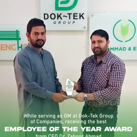 CEO Dr. Zahoor Ahmad presenting Employee of the Year award to GM Mr. Faisal at DOK-TEK Group.